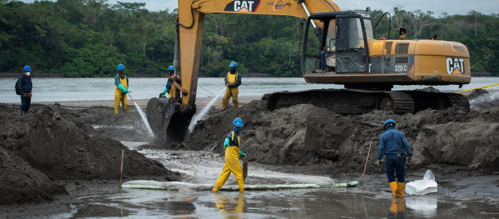 workers removing oil from the river and its shores